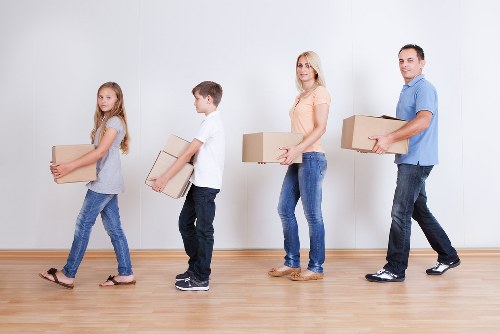 Professional house movers handling household furniture and boxes in Chelsea