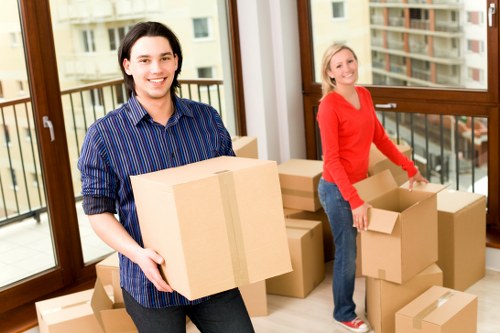 Professional movers transporting furniture from a Chelsea property